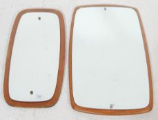 A pair of vintage 20th century teak wood frame wall hanging mirrors in oval shape. Measures 70 cm