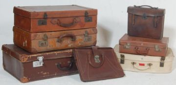 A collection of retro vintage circa 1950s mid century leather suitcases / satchels of various sizes.