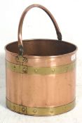 A late 19th Century early 20th Century Victorian copper and brass cylindrical coal bucket scuttle