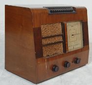 A 1920's EKCO Type P.B.510 walnut valve radio having a large glass dial to the right, front