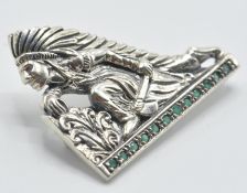 A stamped sterling silver brooch in the form of a Native American fighter wearing a feather