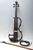 A cased Hidersine 4/4 full sized electric violin complete with the case and bow. Makers label
