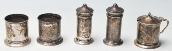 A group of four silver hallmarked cruets to include two pepperettes, two salt cellars and a lidded