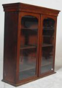 A Victorian 19th century mahogany library bookcase cabinet. Raised on a plinth banded base with