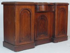 A Victorian 19th century inverted breakfront mahogany sideboard – credenza being raised on a