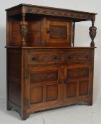 A 20th century Jacobean revival oak court cupboard in the manner of Jaycee / Old Charm Wood Bros.