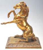 A vintage 20th century brass horse mantle ornament sitting on the back legs with front legs