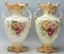 A pair of Victorian 19th century Staffordshire twin handled vases. The pottery vases having gilt
