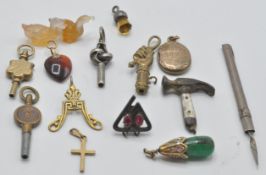 A collection of vintage pendants and related items to include a Chinese green stone pendant set with
