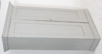 A 19th century Victorian shabby chic painted large school cupboard being raised on a plinth base