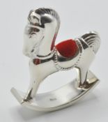 A stamped sterling silver 925 pincushion in the form of a rocking horse with velvet cushion to the