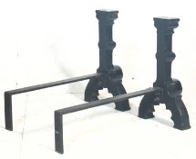 A pair of substantial antique Victorian Jacobean style cast iron gothic fire dogs / andirons
