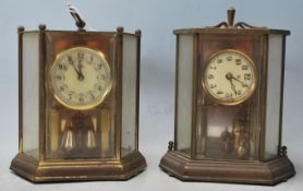 Two vintage late 20th Century glass cased anniversary clocks of hexagonal form both raised on
