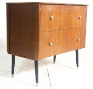 A vintage mid century teak wood chest of drawers. The chest being raised on eboniesed dinette legs w