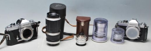 A pair of vintage NIKKORMAT FT2 cameras serial number 5061766 and 5218438 along with spare lenses to