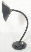 A 1920's cast metal and ebonised Industrial desk / table lamp. Raised on black octagonal base with