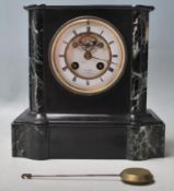 An early 20th Century green veined marble and black slate mantle clock having a chamfered top over a