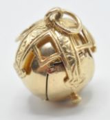 A hallmarked 9ct gold Masonic ball pendant opening to reveal pyramids with engraved symbols