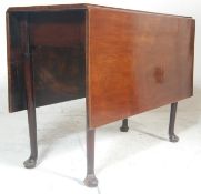 A 19th century George III mahogany drop leaf dining table. Raised on reeded, turned and tapering