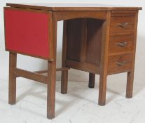 A retro vintage 1950s mid century air ministry style oak writing table / desk having a red formica