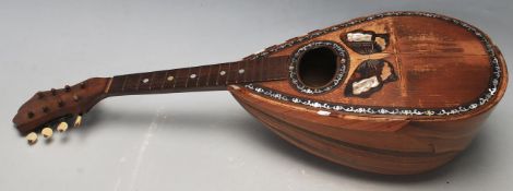 An early 20th Century Stridente Italian olive wood mandolin instrument having an oval soundhole with
