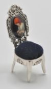 A silver 925 pin cushion in the form of a Thomas Chippendale chair having blue baize cushion to