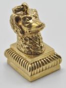 A contemporary gold plated letter seal in the form