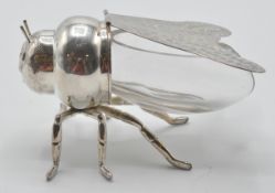 A silver plated and blue glass honey pot in the fo