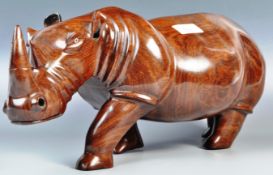 A STUNNING LARGER AND IMPRESSIVE HAND CARVED ROSEWOOD RHINO STATUE