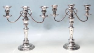A PAIR OF 20TH CENTURY SILVER PLATED CANDLESTICKS.