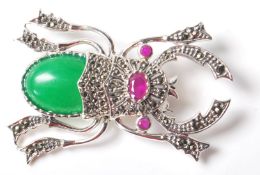A STAMPED STERLING SILVER SCRAB BEETLE BROOCH SET WITH JADEITE.
