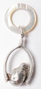 1919 HALLMARKED SILVER AND MOTHER OF PEARL BABY RATTLE.