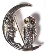 A STAMPED STERLING SILVER BROOCH DEPICTING AN OWL SAT UPON A CRESCENT MOON