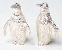 A SILVER PLATED CRUET SET IN THE FORM OF PAIR OF PENGUINS.