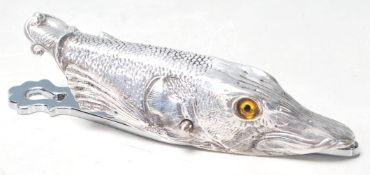 A SILVER PLATES PAPER CLIP / ORGANIZER IN THE FORM OF A FISH.