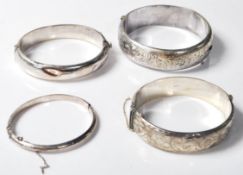 FOUR VINTAGE SILVER ENGRAVED BANGLES