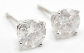 A PAIR OF STAMPED 14K WHITE GOLD DIAMOND STUD EARR