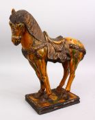 A CHINESE SANCAI POTTERY MODEL OF A STRIDING HORSE, 42cm high x 35cm,