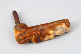 A CARVED BONE WALKING STICK HANDLE, carved with a nude, dated 1910.