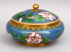 A CHINESE 20TH CENTURY CLOISONNE JAR & COVER, blue ground with floral decoration, 18cm.