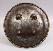 A 19TH CENTURY PERSIAN SILVER INLAID CHILDS SHIELD, with carved panels of arabic script, figures and