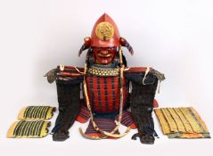 A GOOD JAPANESE EDO PERIOD RED AND GOLD LACQUERED SUIT OF ARMOUR, the museum quality suit of