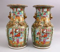 A GOOD PAIR OF 19TH CENTURY CHINESE CANTON FAMILLE ROSE PORCELAIN VASES, the body with panel
