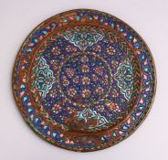 A GOOD 19TH CENTURY SYRIAN ENAMEL CIRCULAR METAL DISH, with raised enamel decoration, 25cm