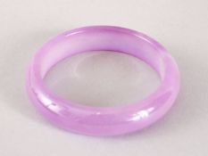 A 19TH / 20TH CENTURY CHINESE CARVED PURPLE AGATE BANGLE, 7.2cm & internal 5.3cm.