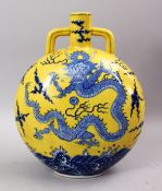 A GOOD CHINESE FAMILLE JAUNE BLUE & WHITE PORCELAIN DRAGON MOON FLASK, the yellow ground bearing