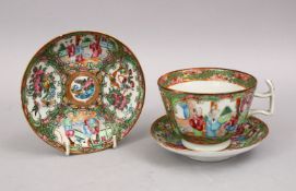 A 19TH CENTURY CHINESE CANTON FAMILLE ROSE PORCELAIN SAUCERS & CUP, with panel decoration of
