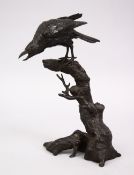 A GOOD JAPANESE MIJI PERIOD BRONZE OKIMONO OF A BIRD, seated upon a stylized wooded outcrop, the