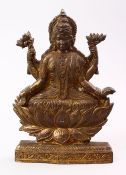 A GOOD INDIAN GILT BRONZE FIGURE OF BUDDHA, multi arm goddess seated, 28cm high.