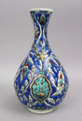 A TURKISH KUTAHIYA POTTERY SIGNED VASE, with floral decoration and signature to base, 30cm